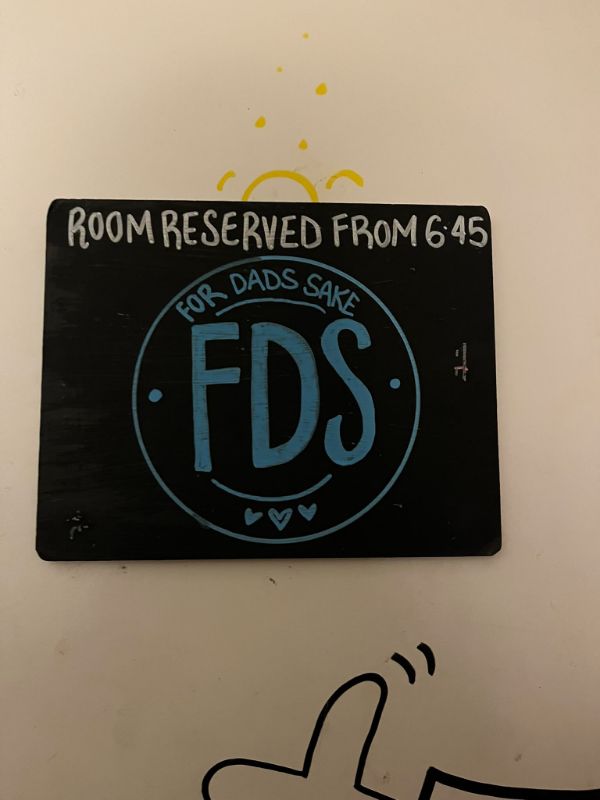 A chalkboard reading Room reserved from 6:45 with a hand-drawn FDS logo